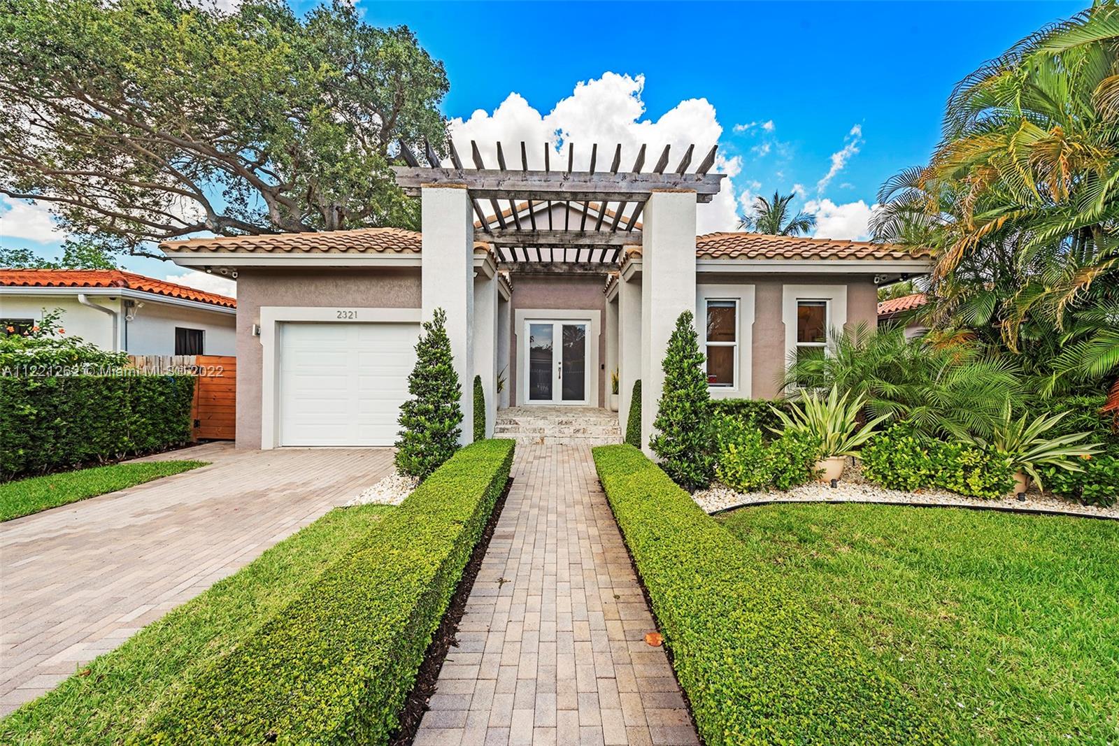 a front view of a house with garden