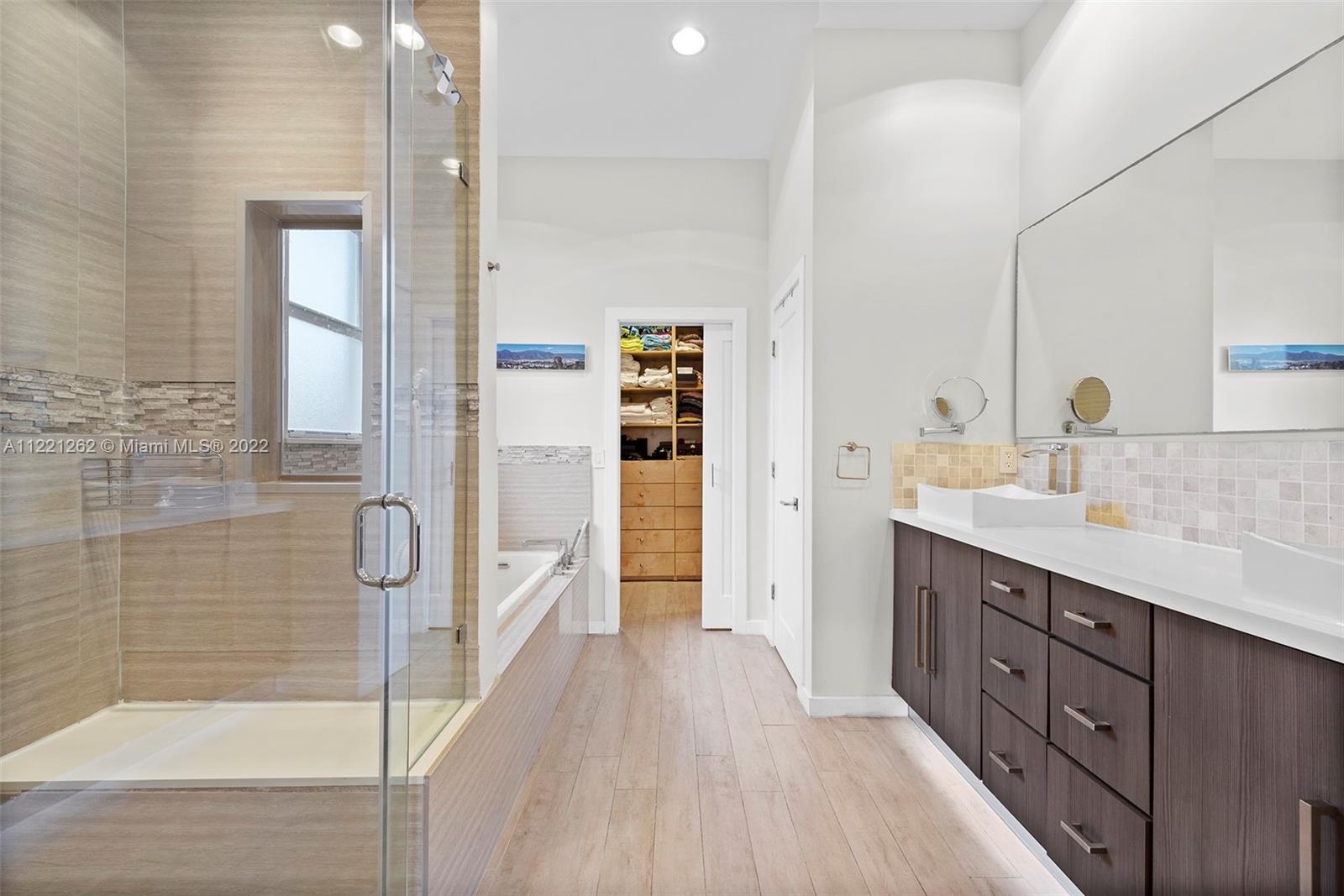 2321 Southwest 19th Street Miami, FL 33145 - Photo 13 of 29 a spacious bathroom with a double vanity sink a large mirror and shower