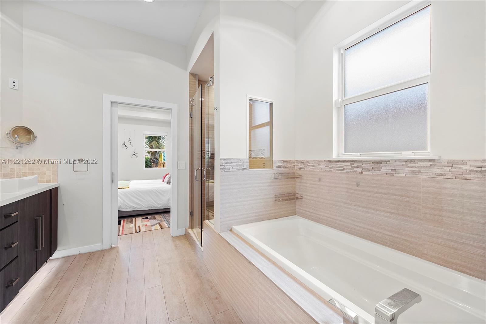 2321 Southwest 19th Street Miami, FL 33145 - Photo 14 of 29 a spacious bathroom with a tub sink and a mirror