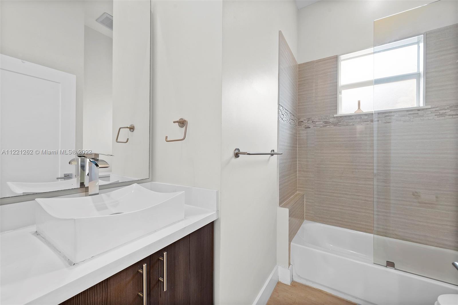2321 Southwest 19th Street Miami, FL 33145 - Photo 17 of 29 a bathroom with a sink and a mirror