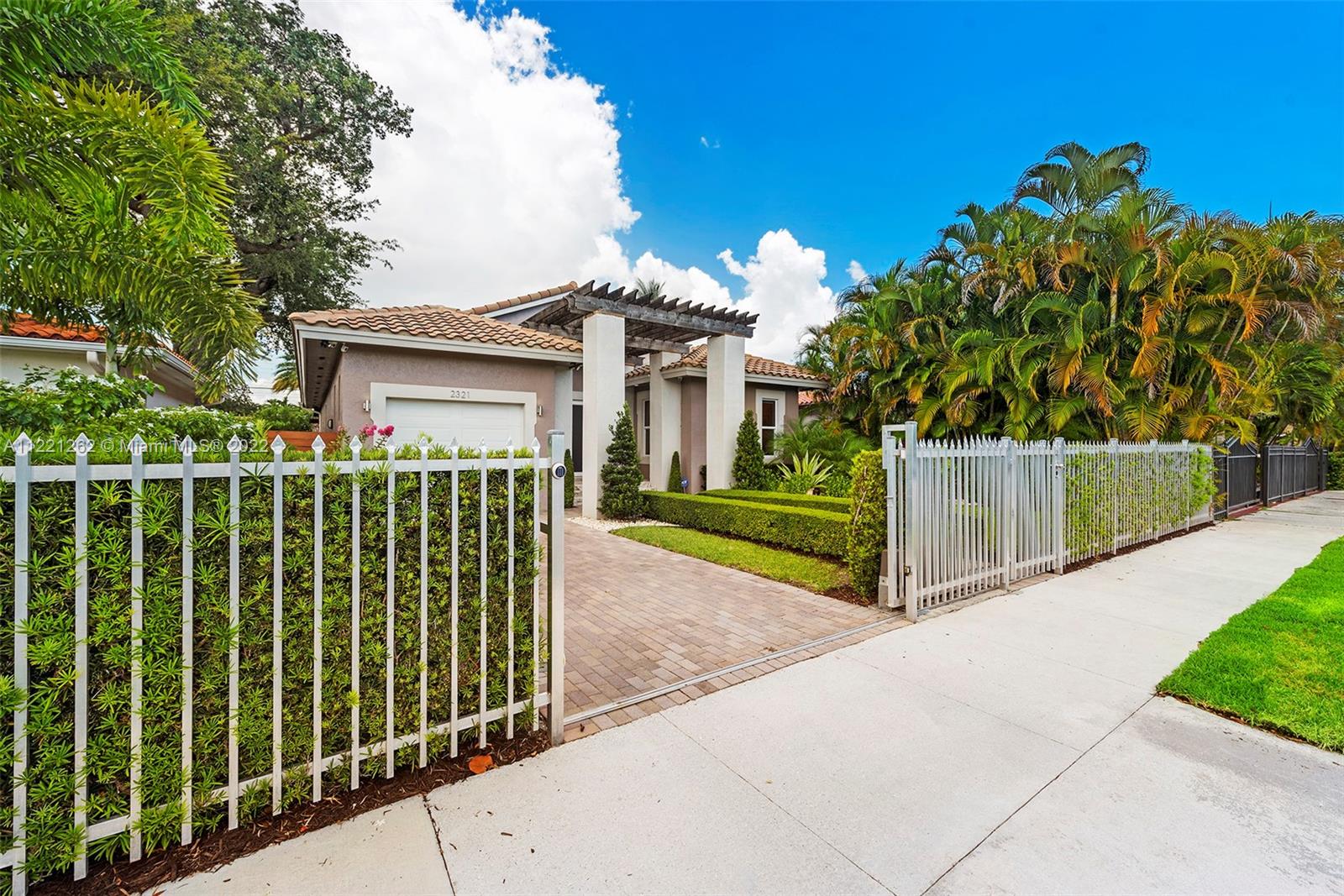 2321 Southwest 19th Street Miami, FL 33145 - Photo 2 of 29 a view of a house with a small yard and plants