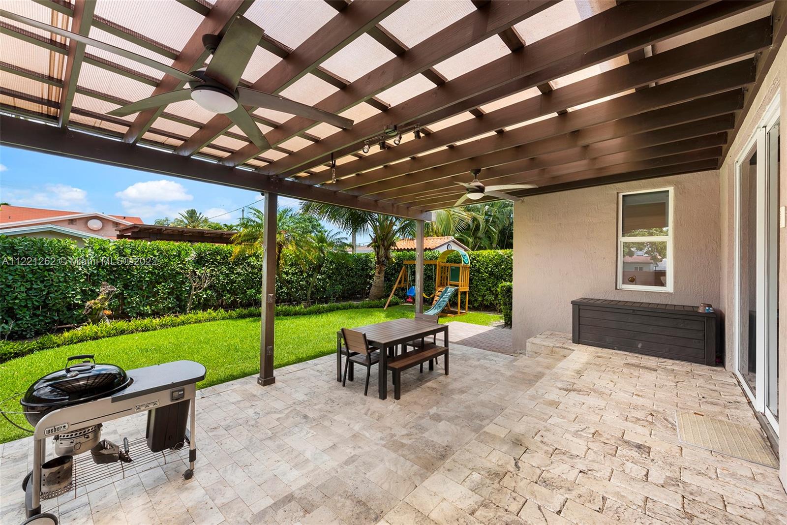 2321 Southwest 19th Street Miami, FL 33145 - Photo 22 of 29 a view of a patio with a table chairs and a yard