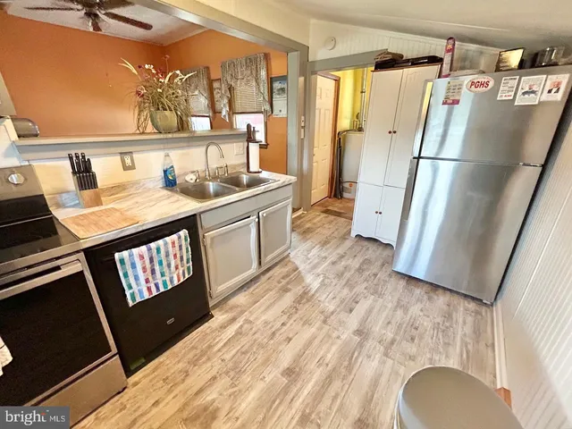 a living room with a fireplace furniture and a large window