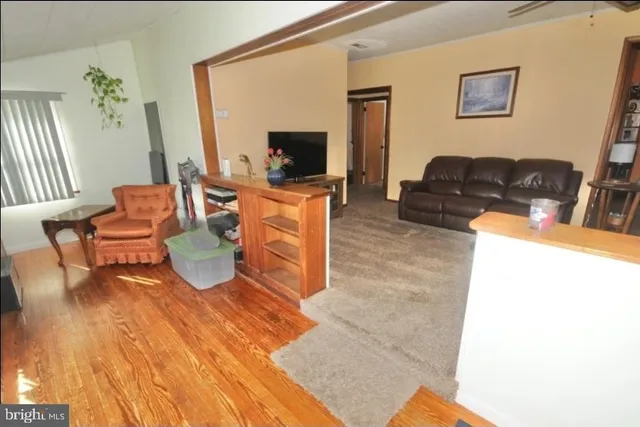 a living room with patio furniture and a flat screen tv