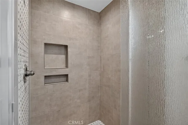 a bathroom with a shower and a sink