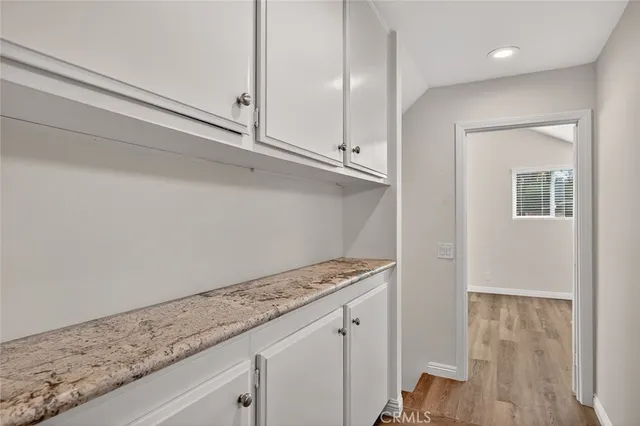 a view of kitchen with granite countertop cabinets and sink