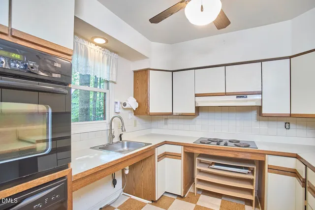 a kitchen with stainless steel appliances a sink and cabinets