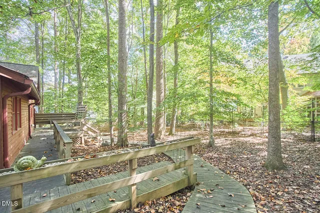 a view of a patio with table and chairs and floor to ceiling window
