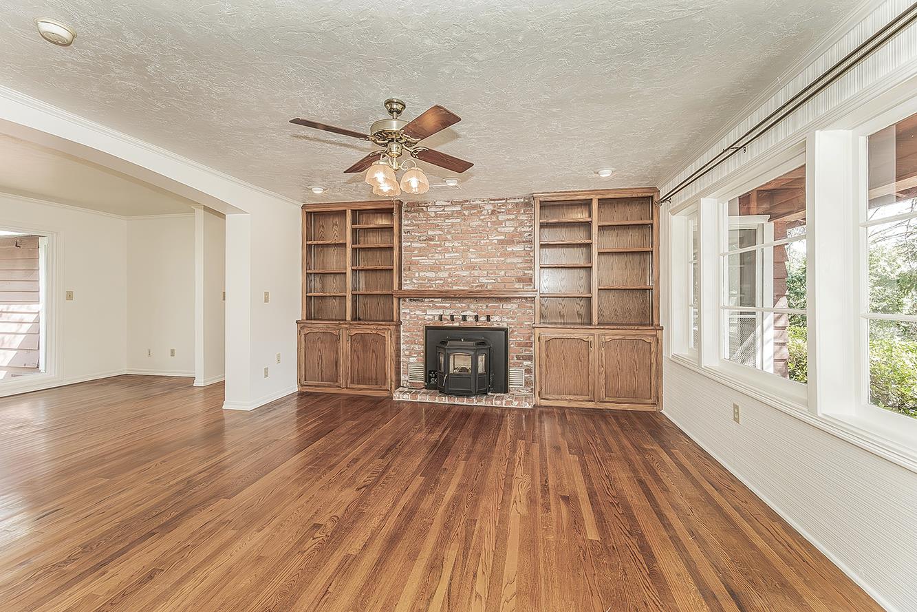 31638 Lodge Road Auberry, CA 93602 - Photo 11 of 90 wooden floor fireplace and windows in an empty room