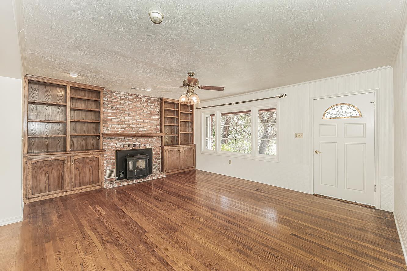 31638 Lodge Road Auberry, CA 93602 - Photo 12 of 90 wooden floor fireplace and windows in an empty room