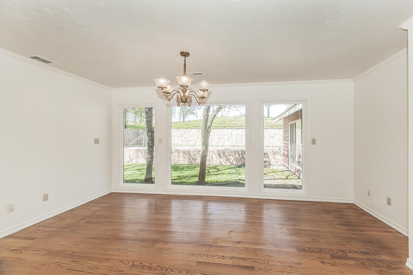 31638 Lodge Road Auberry, CA 93602 - Photo 15 of 90 a view of an empty room with wooden floor and a window