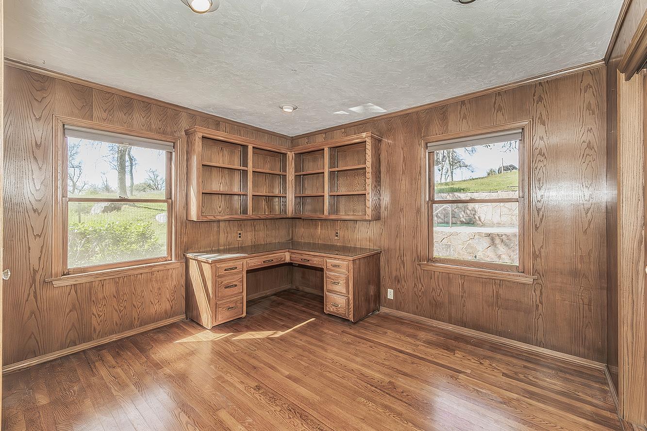 31638 Lodge Road Auberry, CA 93602 - Photo 25 of 90 an empty room with windows wooden floor and brick walls