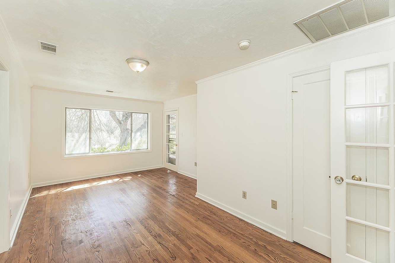 31638 Lodge Road Auberry, CA 93602 - Photo 31 of 90 a view of an empty room with wooden floor and a window