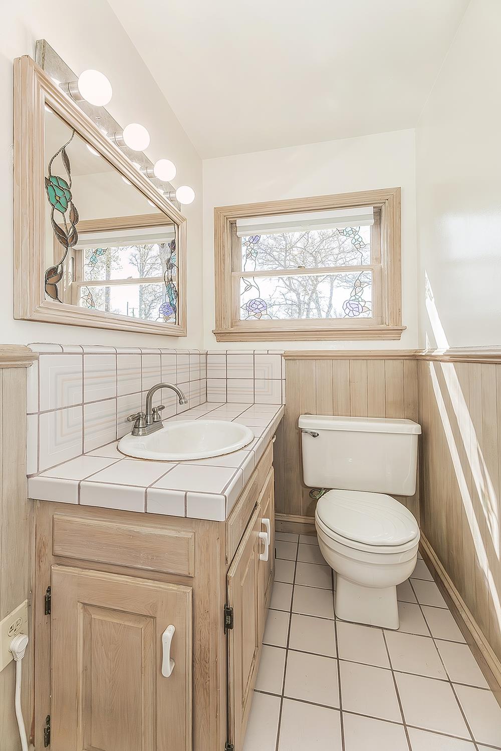 31638 Lodge Road Auberry, CA 93602 - Photo 43 of 90 a bathroom with a sink toilet and window