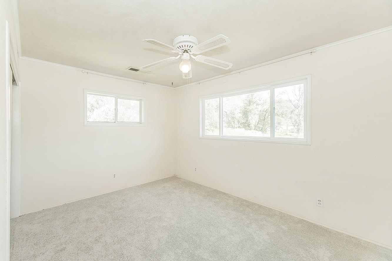 31638 Lodge Road Auberry, CA 93602 - Photo 64 of 90 an empty room with a window and a fan