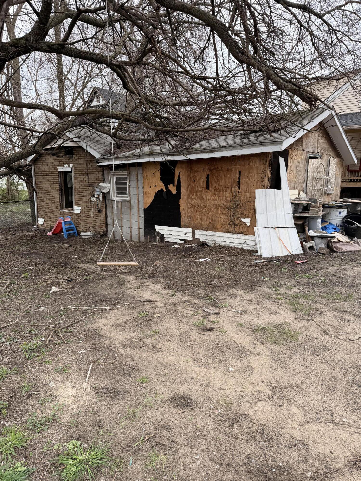 1574 Jennings Street Gary, IN 46404 - Photo 2 of 3 a house with trees in front of it
