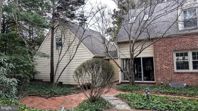 a view of a house with a small yard and potted plants