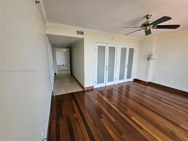 a view of a hallway with wooden floor and staircase