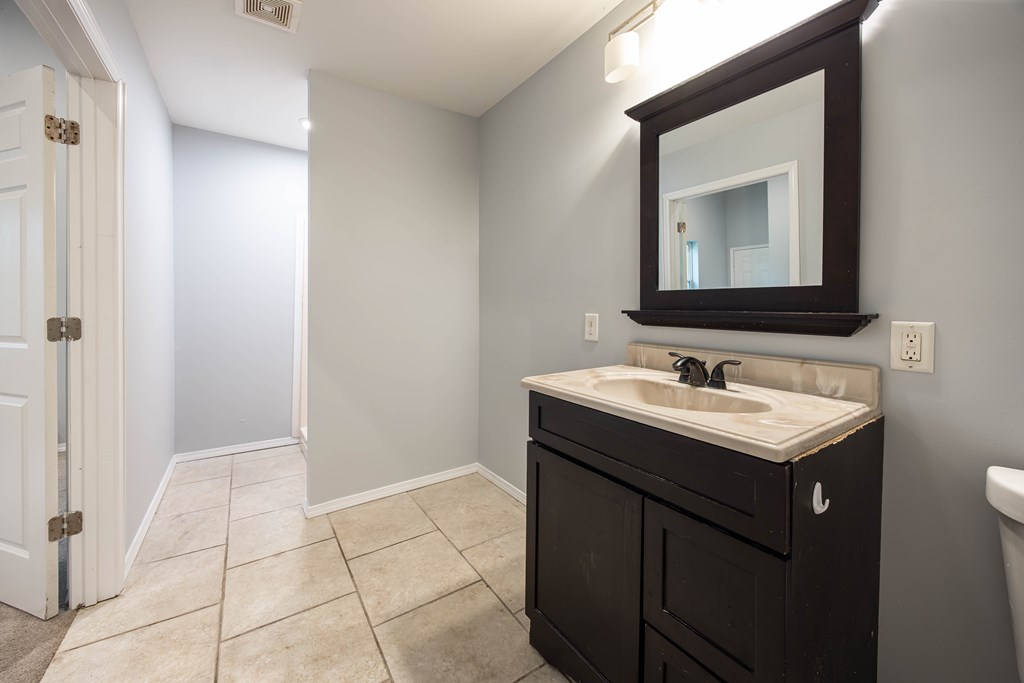 2113 Summerville Road Phenix City, AL 36867 - Photo 27 of 37 a bathroom with a sink and a mirror