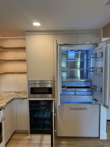 a kitchen with a refrigerator and a stove