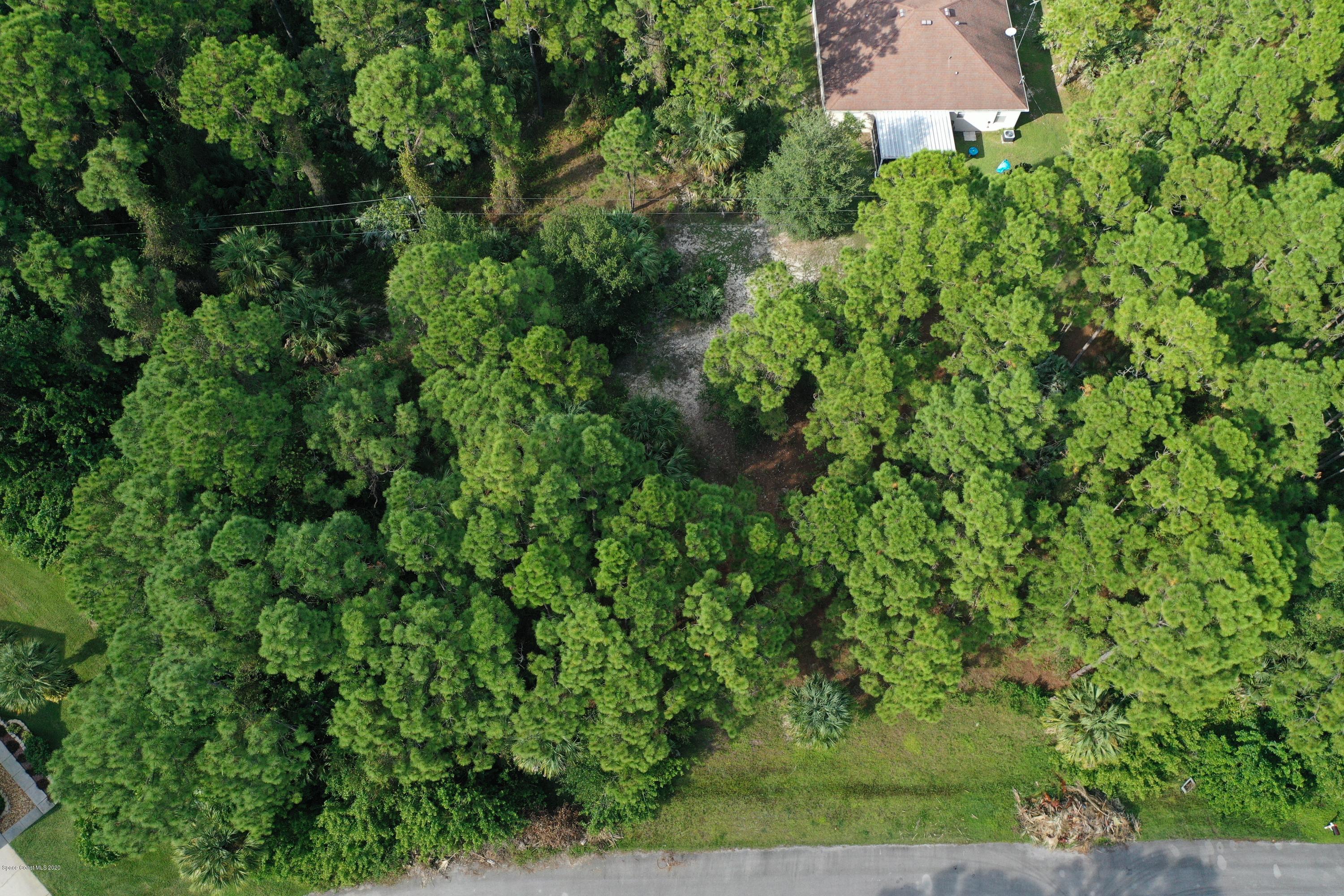 730 Gibbons Road Southwest Palm Bay, FL 32908 - Photo 3 of 11 an aerial view of residential house with outdoor space and trees all around