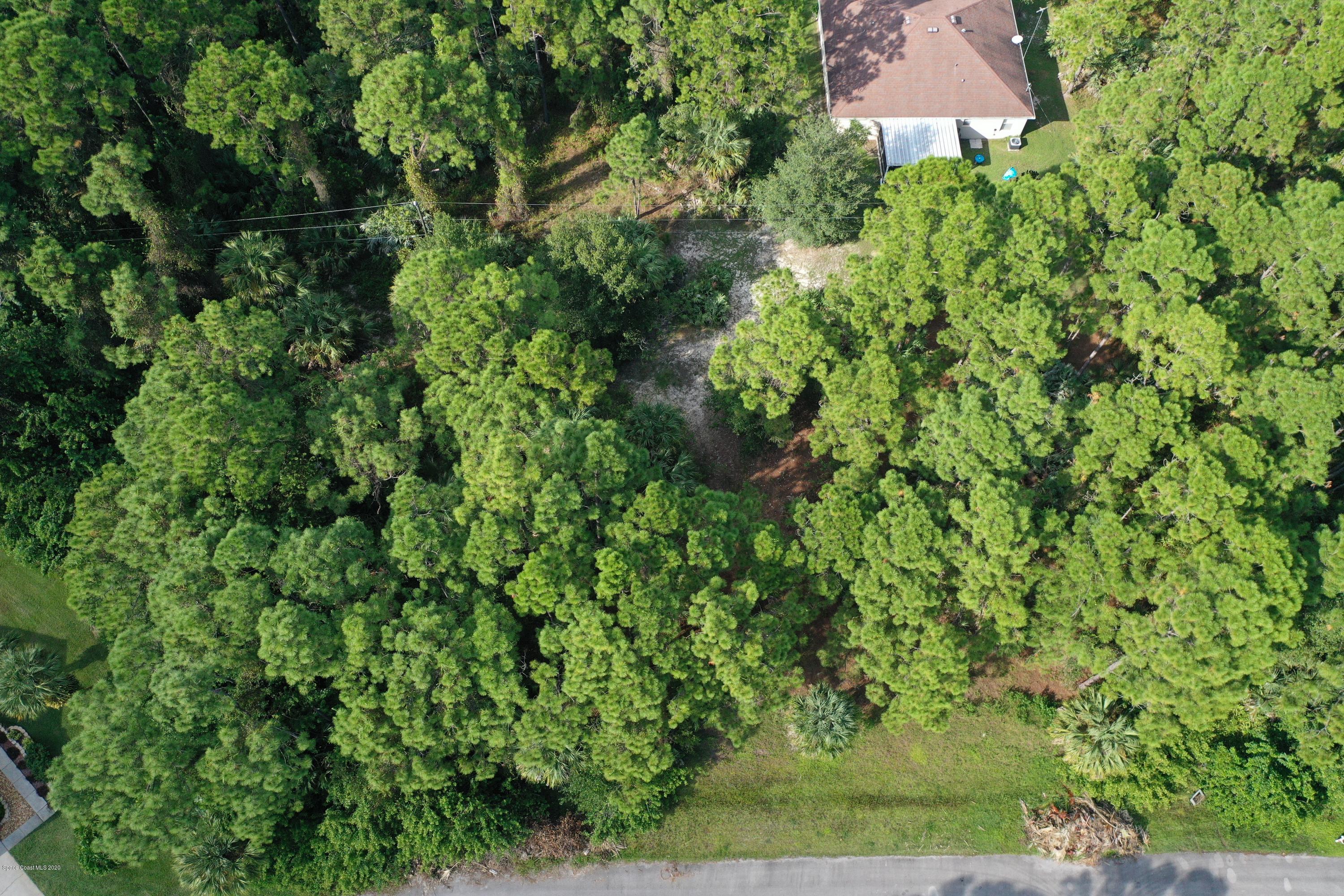 730 Gibbons Road Southwest Palm Bay, FL 32908 - Photo 4 of 11 an aerial view of residential house with outdoor space and trees all around