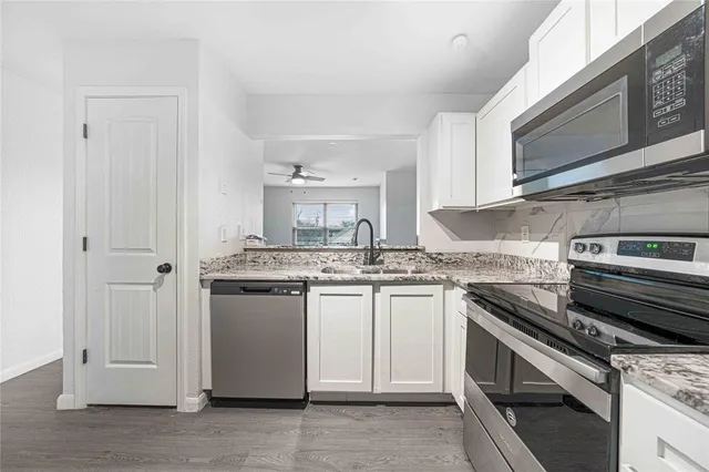 a kitchen with stainless steel appliances granite countertop a stove and a sink