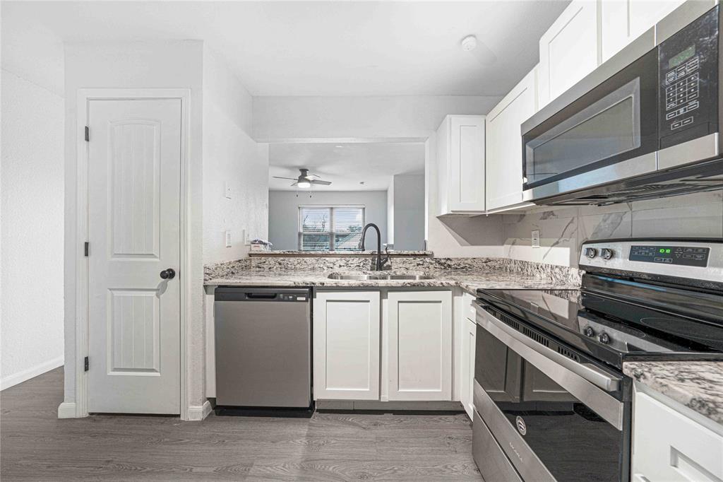 2200 East Trinity Mills Road, Unit 510 Carrollton, TX 75006 - Photo 1 of 17 a kitchen with stainless steel appliances granite countertop a stove and a sink