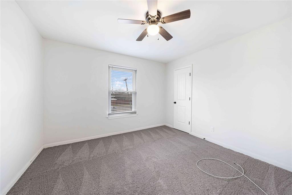 2200 East Trinity Mills Road, Unit 510 Carrollton, TX 75006 - Photo 14 of 17 an empty room with fan and windows