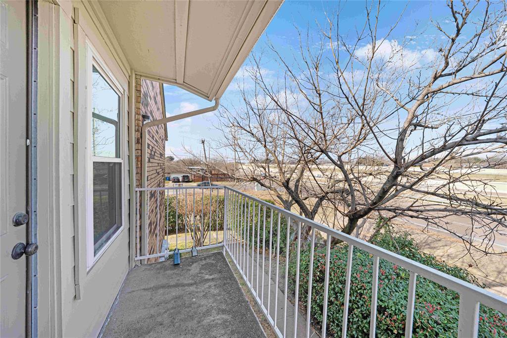 2200 East Trinity Mills Road, Unit 510 Carrollton, TX 75006 - Photo 15 of 17 a view of a balcony with trees