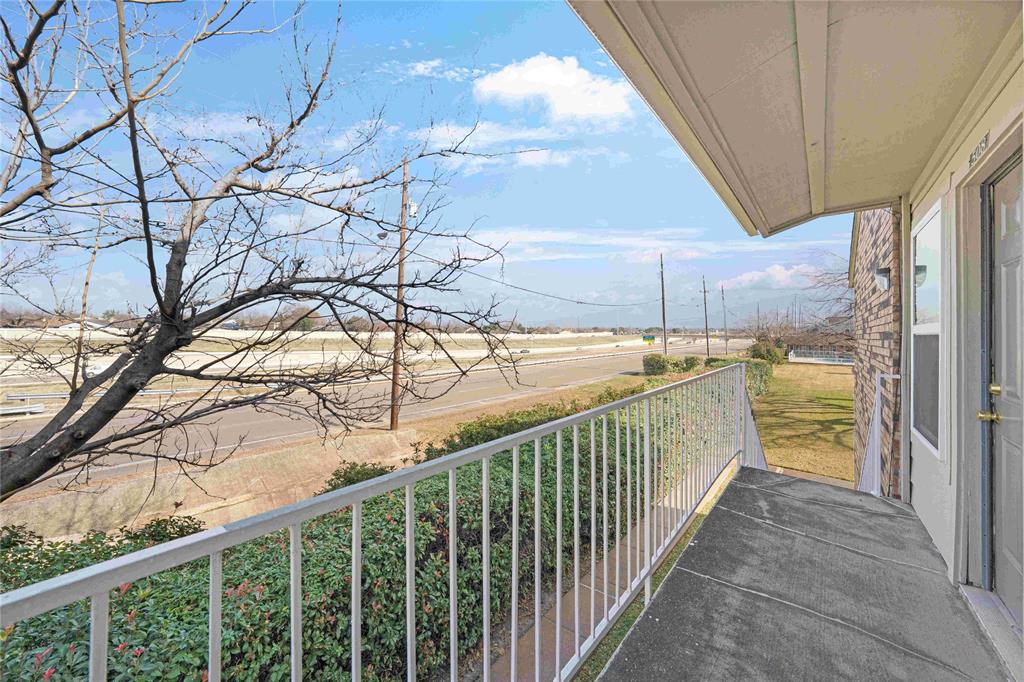 2200 East Trinity Mills Road, Unit 510 Carrollton, TX 75006 - Photo 16 of 17 a view of a balcony with a tree