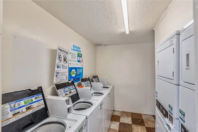 a work room with furniture a rug and a window