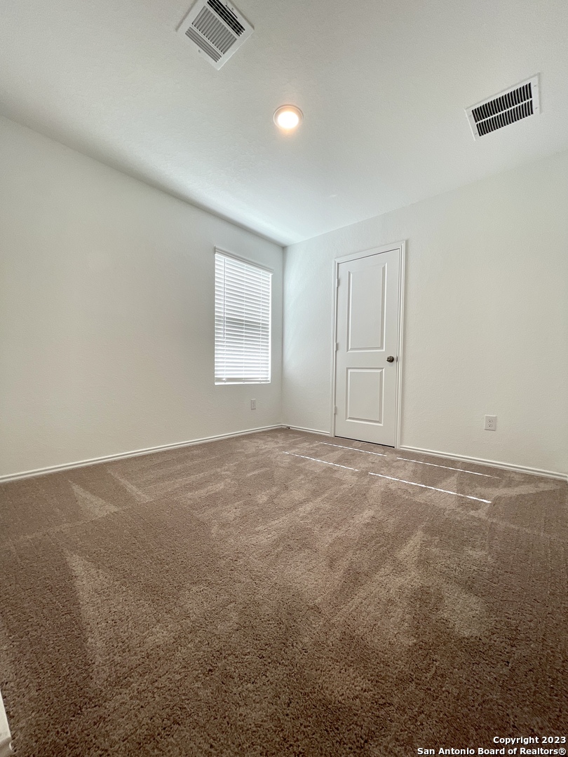 7274 Pasture Run San Antonio, TX 78252 - Photo 12 of 17 an empty room with windows and closet