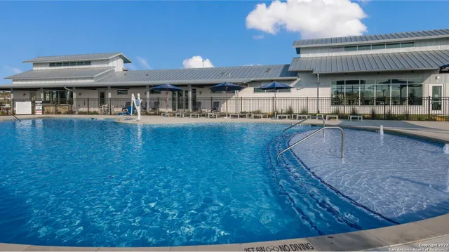 a view of a swimming pool with a patio