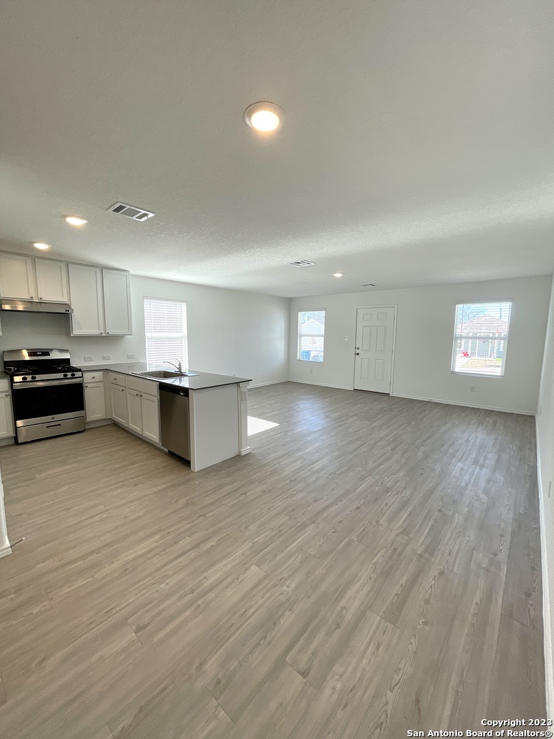 7274 Pasture Run San Antonio, TX 78252 - Photo 6 of 17 a view of a kitchen with a sink and a stove top oven