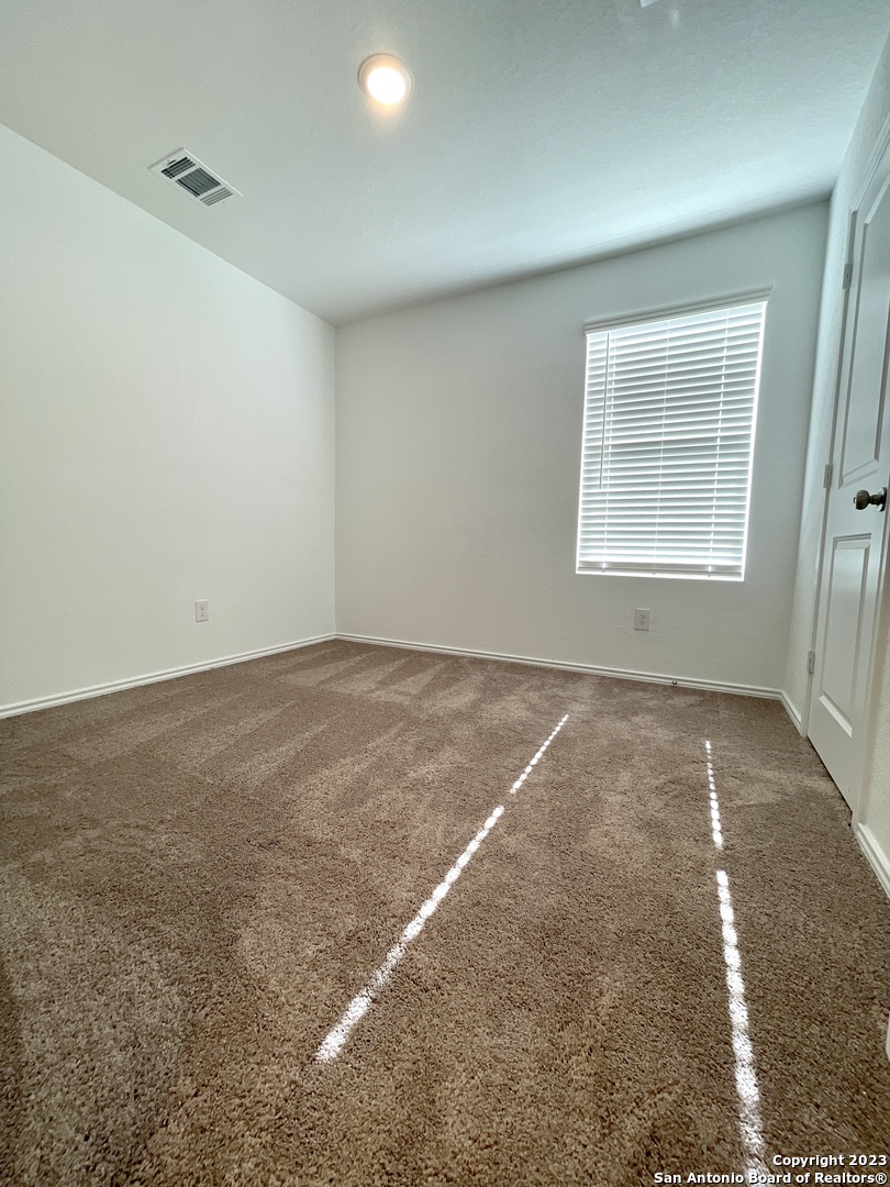 7274 Pasture Run San Antonio, TX 78252 - Photo 10 of 17 en empty room with windows