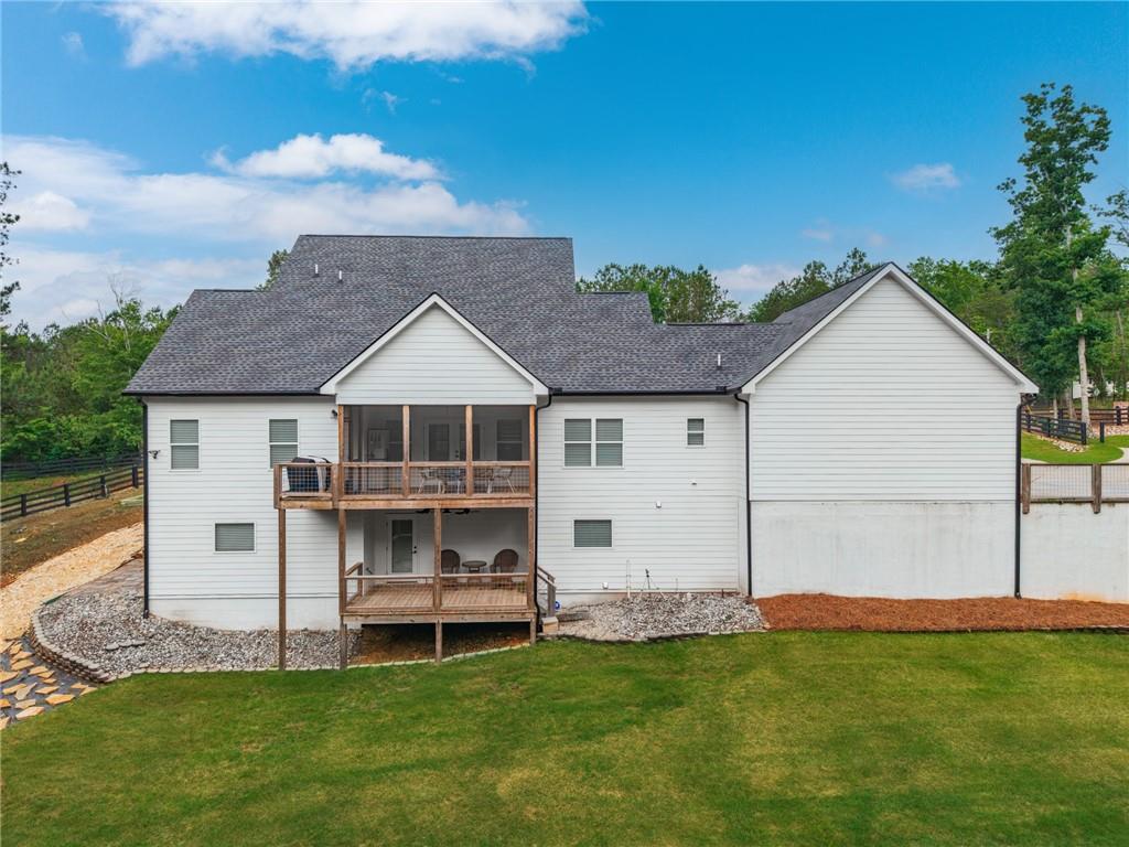 2250 Sperin Road Ball Ground, GA 30107 - Photo 6 of 56 a front view of a house with a garden and yard