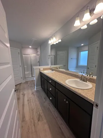 a spacious bathroom with a double vanity sink and a mirror