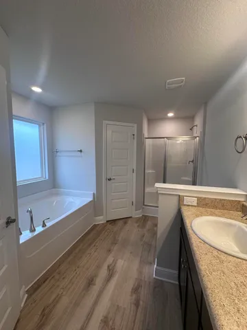 a bathroom with a tub sink and mirror
