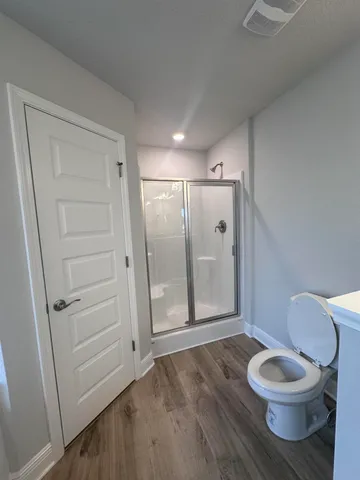 a bathroom with a toilet and a shower
