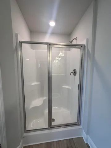 a bathroom with a glass shower door