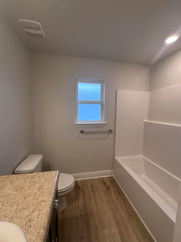 a view of empty room with window and fireplace