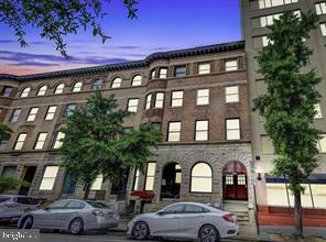 a front view of a building with parking space