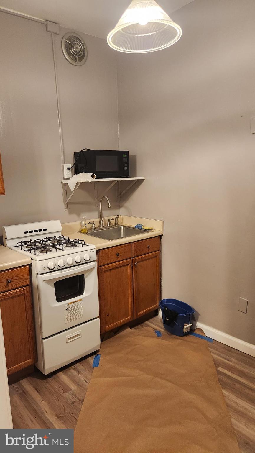1115 North Calvert Street Baltimore, MD 21202 - Photo 11 of 35 a kitchen with a stove and a sink