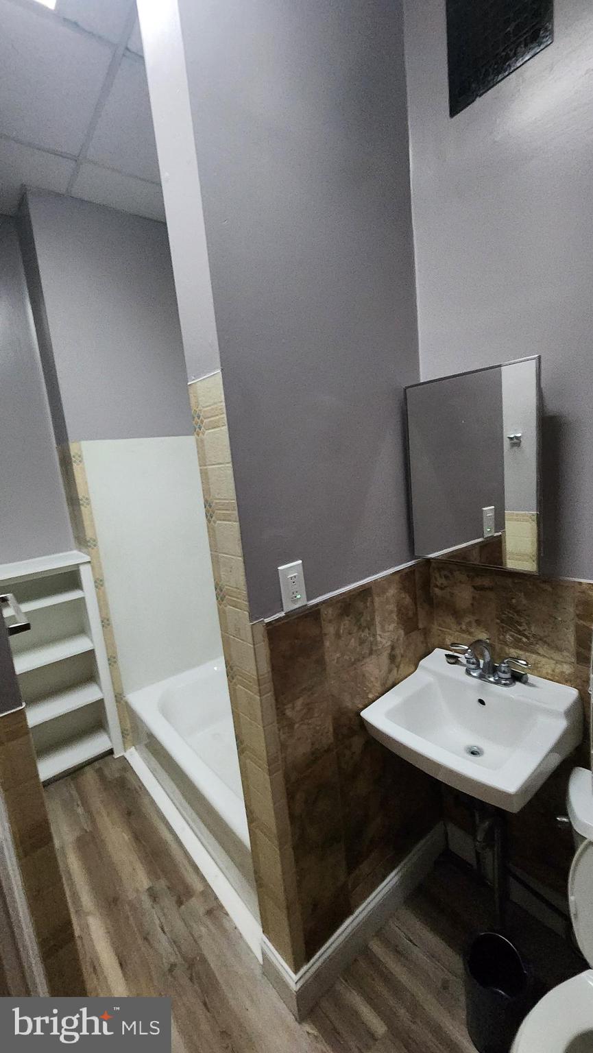 1115 North Calvert Street Baltimore, MD 21202 - Photo 13 of 35 a bathroom with a sink and a mirror