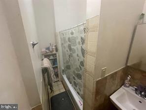1115 North Calvert Street Baltimore, MD 21202 - Photo 20 of 35 a bathroom with a sink a mirror and shower