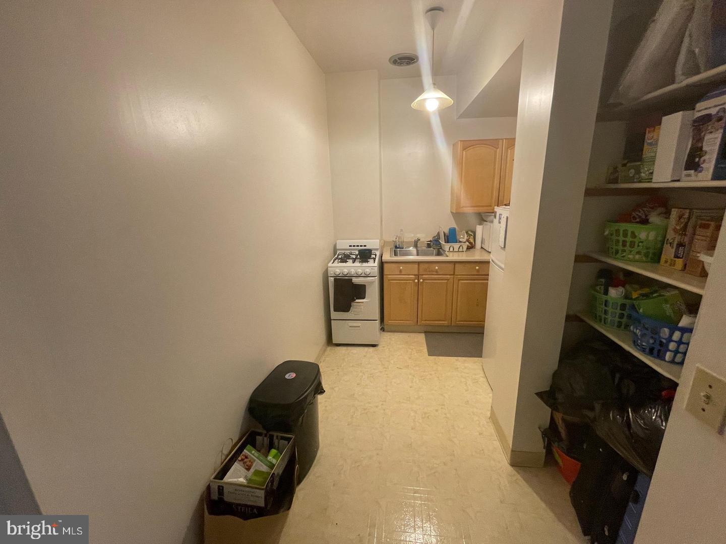 1115 North Calvert Street Baltimore, MD 21202 - Photo 21 of 35 a kitchen with cabinets and a stove