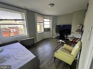 1115 North Calvert Street Baltimore, MD 21202 - Photo 29 of 35 a living room with furniture and a flat screen tv