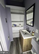 1115 North Calvert Street Baltimore, MD 21202 - Photo 30 of 35 a bathroom with a sink and a window