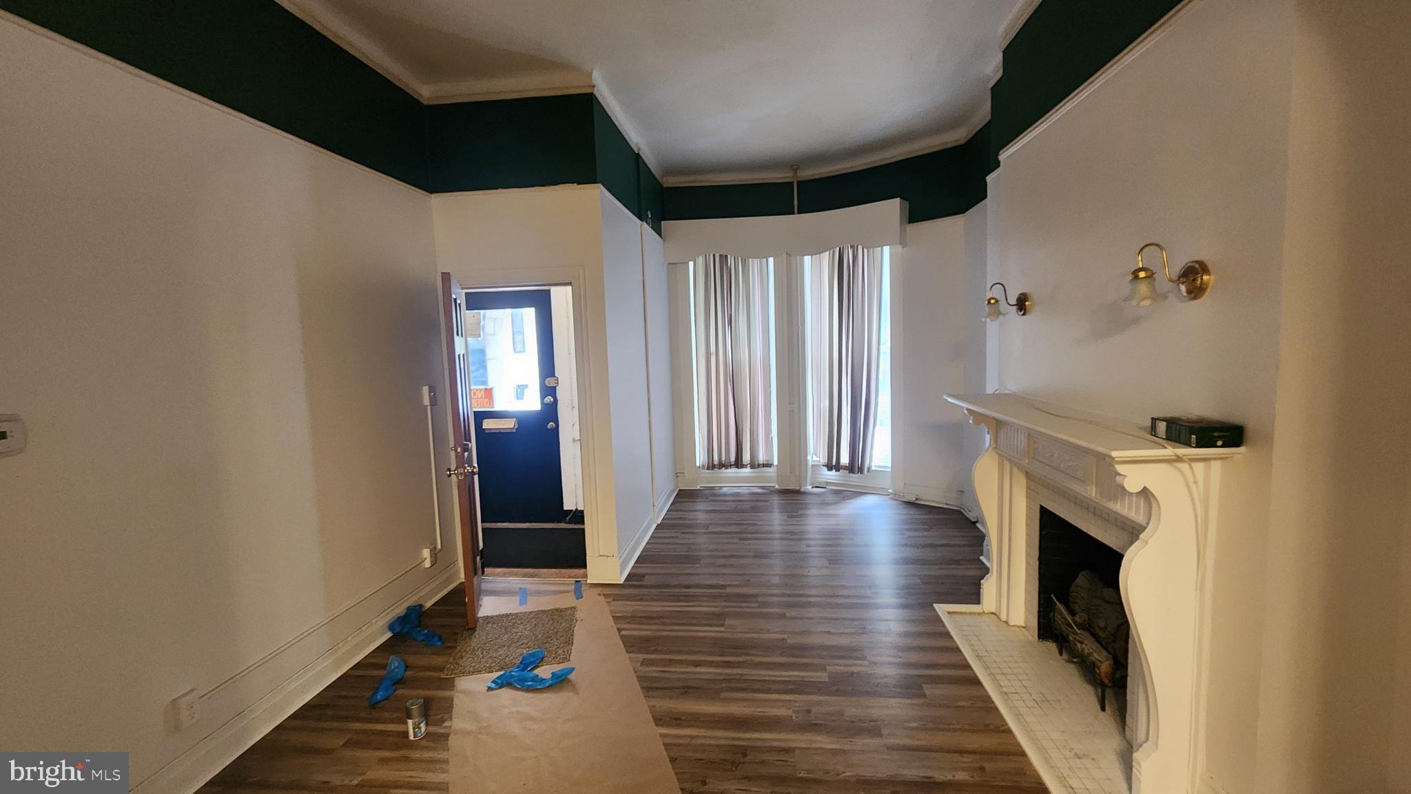 1115 North Calvert Street Baltimore, MD 21202 - Photo 33 of 35 a view of hallway with wooden floor and fireplace